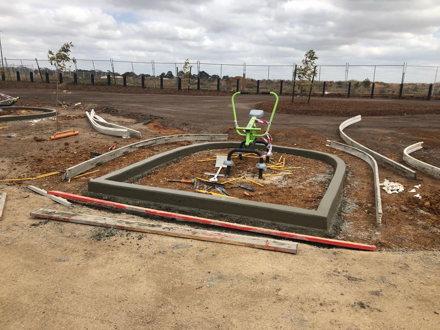 Curved concrete surround freshly stripped around playground equipment