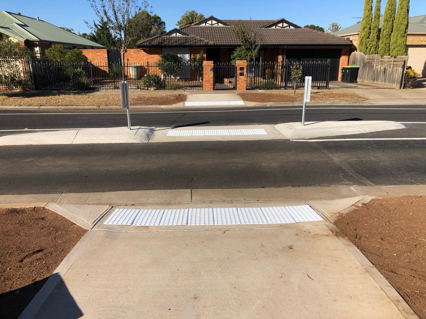 Finished pair of pram crossings with tactile pavers and new footpath across a residential street