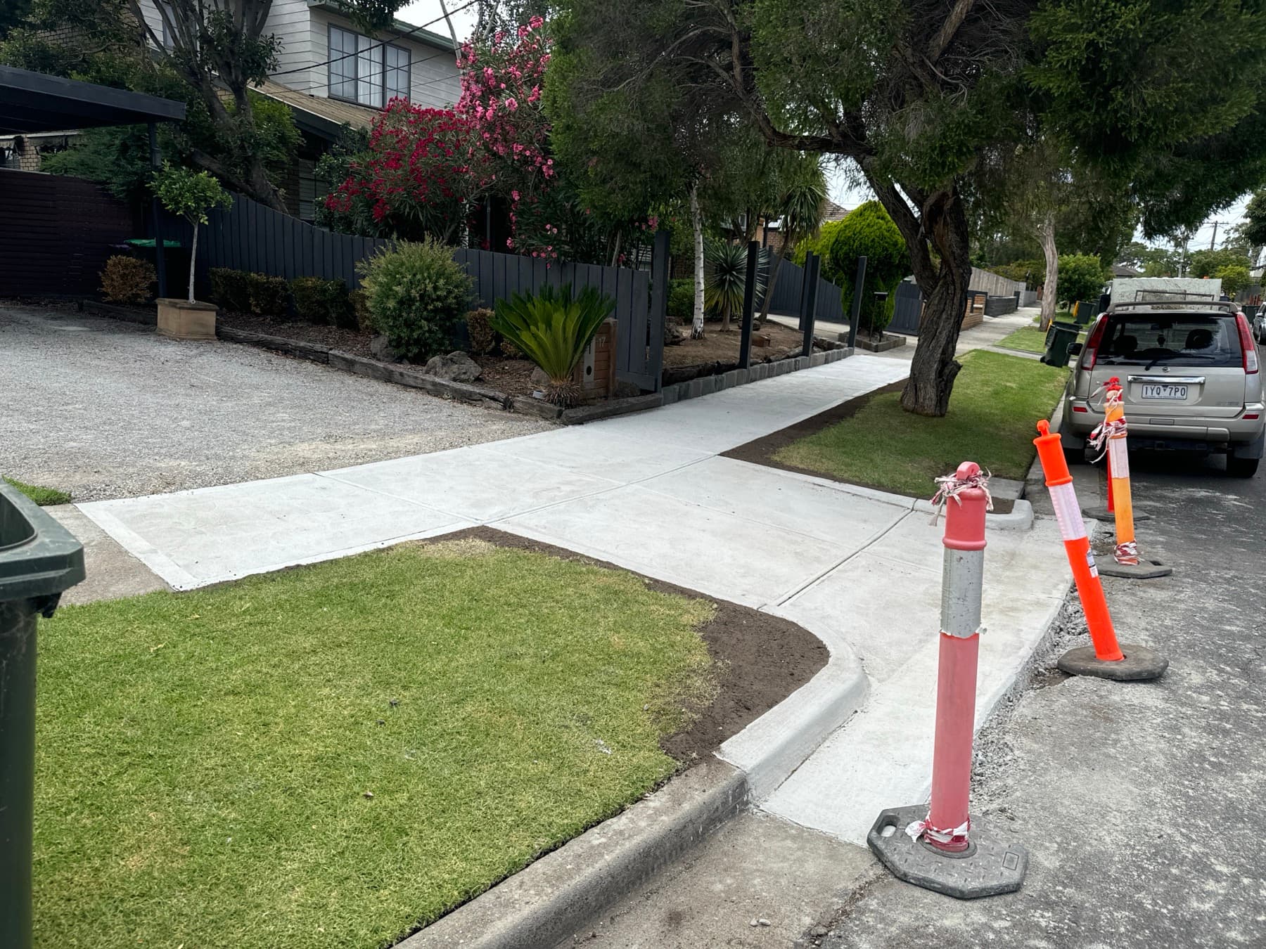 Finished vehicle crossing and footpath meeting a landscaped garden frontage
